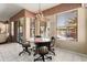Breakfast nook with view of outdoor pool area, large picture windows, and a modern chandelier at 3797 N 156Th N Dr, Goodyear, AZ 85395