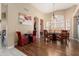 Elegant dining area with wood flooring, arched openings, and abundant natural light at 3797 N 156Th N Dr, Goodyear, AZ 85395