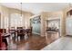 Open dining room with wood floors, elegant lighting, and views into the adjacent living room at 3797 N 156Th N Dr, Goodyear, AZ 85395