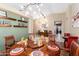 Dining room with decorative chandelier, table setting, and floating shelves on an accent wall at 3797 N 156Th N Dr, Goodyear, AZ 85395