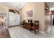 Elegant foyer with tile flooring, wood furnishings, and a decorative chandelier at 3797 N 156Th N Dr, Goodyear, AZ 85395