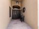Charming front entrance with an iron double door, seating area, and stone flooring at 3797 N 156Th N Dr, Goodyear, AZ 85395