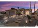 Stunning home featuring desert landscaping, stone pathway, a two-car garage, and vibrant sunset skies at 3797 N 156Th N Dr, Goodyear, AZ 85395