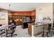 Spacious kitchen featuring large island, stainless steel appliances, terracotta accent wall, and breakfast nook at 3797 N 156Th N Dr, Goodyear, AZ 85395