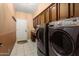 Laundry room with a front-load washer and dryer, and plenty of cabinet storage at 3797 N 156Th N Dr, Goodyear, AZ 85395