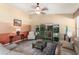 Living room with a modern entertainment center, neutral-toned furniture, and layered lighting at 3797 N 156Th N Dr, Goodyear, AZ 85395