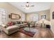 Bright living room with a comfortable sectional sofa, vaulted ceiling, and plantation shutters at 3797 N 156Th N Dr, Goodyear, AZ 85395