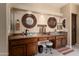 Luxury main bathroom with dual glass bowl sinks, dark wood cabinetry, and recessed lighting at 3797 N 156Th N Dr, Goodyear, AZ 85395