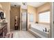Light and airy main bath featuring a soaking tub, glass block window, and step-in shower at 3797 N 156Th N Dr, Goodyear, AZ 85395