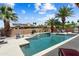 A pool with waterfall, lush palm trees, a desert landscape, and outdoor furniture at 3797 N 156Th N Dr, Goodyear, AZ 85395