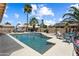 A stunning pool and spa area framed by lush palm trees and a blue sky at 3797 N 156Th N Dr, Goodyear, AZ 85395
