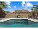 Backyard showcasing a pool with a waterfall feature and well-manicured desert landscaping at 3797 N 156Th N Dr, Goodyear, AZ 85395