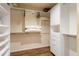 A bright walk-in closet has custom shelving and wood flooring at 3797 N 156Th N Dr, Goodyear, AZ 85395