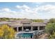 Aerial view of a home highlighting the swimming pool, spa, patio area, landscaping, and architectural design at 39847 N 105Th Pl, Scottsdale, AZ 85262