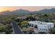A gorgeous aerial view showcasing the property's desert landscaping, brick paved driveway, architectural features, and mountain backdrop at 39847 N 105Th Pl, Scottsdale, AZ 85262