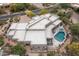 An aerial view displays a home with a pool, patio, desert landscaping, offering a private outdoor retreat at 39847 N 105Th Pl, Scottsdale, AZ 85262