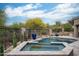 Tranquil backyard with a pool, spa, and privacy fencing surrounded by desert plants at 39847 N 105Th Pl, Scottsdale, AZ 85262