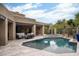 Beautiful backyard with a sparkling pool, mature landscaping, and desert views at 39847 N 105Th Pl, Scottsdale, AZ 85262