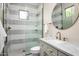 Modern bathroom featuring a glass shower, gray tile accents, and sleek hardware at 39847 N 105Th Pl, Scottsdale, AZ 85262