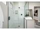 Modern bathroom with glass-enclosed shower, white subway tile, and open doorway at 39847 N 105Th Pl, Scottsdale, AZ 85262