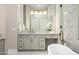 Elegant bathroom showcasing double vanity, marble countertops, and view of freestanding soaking tub at 39847 N 105Th Pl, Scottsdale, AZ 85262