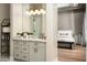 Stylish bathroom showing double sink vanity, decorative mirror, and partial view into the main bedroom at 39847 N 105Th Pl, Scottsdale, AZ 85262