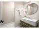 Elegant powder room featuring marble countertop, gold fixtures, and round mirror at 39847 N 105Th Pl, Scottsdale, AZ 85262