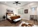 Comfortable bedroom featuring a dark wood bed frame, hardwood floors, and ample natural light at 39847 N 105Th Pl, Scottsdale, AZ 85262