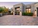 Home features a beautiful desert landscape, brick driveway, and a modern entryway with decorative plants at 39847 N 105Th Pl, Scottsdale, AZ 85262