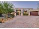 Stunning home featuring a desert landscape, brick driveway, and a custom front door with decorative plantings at 39847 N 105Th Pl, Scottsdale, AZ 85262