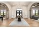 Elegant foyer with wood floors, a statement chandelier, and views of the living spaces at 39847 N 105Th Pl, Scottsdale, AZ 85262