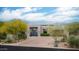 Attractive home with desert landscaping, circular driveway, and modern front door at 39847 N 105Th Pl, Scottsdale, AZ 85262