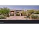 A gorgeous front exterior showcasing the property's desert landscaping, brick paved driveway, and architectural features at 39847 N 105Th Pl, Scottsdale, AZ 85262