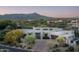 A gorgeous front exterior showcasing the property's desert landscaping, brick paved driveway, and architectural features at 39847 N 105Th Pl, Scottsdale, AZ 85262