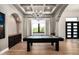Chic game room with a pool table, custom built-ins, coffered ceiling, and ample lighting at 39847 N 105Th Pl, Scottsdale, AZ 85262