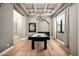 Spacious game room featuring a pool table, elegant chandelier, and ample natural light at 39847 N 105Th Pl, Scottsdale, AZ 85262