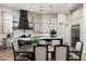 Modern kitchen with a large island, granite countertops, stainless steel appliances and a nearby dining area at 39847 N 105Th Pl, Scottsdale, AZ 85262