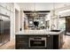 Granite kitchen island with stainless steel appliances opens to the living room at 39847 N 105Th Pl, Scottsdale, AZ 85262
