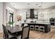 Modern kitchen with a large island, granite countertops, stainless steel appliances and a nearby dining area at 39847 N 105Th Pl, Scottsdale, AZ 85262
