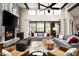 Comfortable living room with a fireplace, high ceilings, and seamless indoor-outdoor flow at 39847 N 105Th Pl, Scottsdale, AZ 85262
