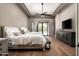 Elegant main bedroom featuring hardwood floors, ceiling fan, and sliding glass doors to outdoor space at 39847 N 105Th Pl, Scottsdale, AZ 85262