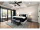 Stylish main bedroom features a ceiling fan, a large glass door, and a black and white theme at 39847 N 105Th Pl, Scottsdale, AZ 85262