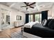 Beautiful bedroom features a beamed ceiling, light walls, and large windows that open to the outside at 39847 N 105Th Pl, Scottsdale, AZ 85262