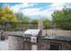 Outdoor kitchen features a built-in grill, counter space, and privacy wall, perfect for outdoor entertaining at 39847 N 105Th Pl, Scottsdale, AZ 85262
