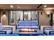 Spacious covered patio with a cozy fire pit and comfortable seating, ideal for year-round enjoyment at 39847 N 105Th Pl, Scottsdale, AZ 85262