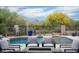 Inviting pool area featuring a sparkling pool, comfortable lounge chairs, and lush desert landscaping with mountain views at 39847 N 105Th Pl, Scottsdale, AZ 85262
