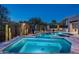 Relaxing pool and hot tub area with beautiful stonework, desert landscaping, and secure fencing at 39847 N 105Th Pl, Scottsdale, AZ 85262