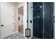 Modern bathroom with navy and white tile, glass enclosed shower, and access to other areas of home at 39847 N 105Th Pl, Scottsdale, AZ 85262