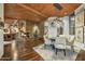 Bright dining area with stone fireplace, wood ceilings, and modern lighting fixture at 41590 N 108Th St, Scottsdale, AZ 85262