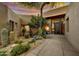 Home entryway featuring a private courtyard with mature cacti, desert landscaping, and statement front door at 41590 N 108Th St, Scottsdale, AZ 85262
